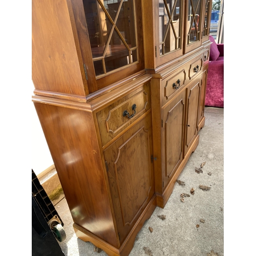 3071 - A YEW WOOD BREAKFRONT FOUR DOOR ASTRAGAL GLAZED BOOKCASE WITH DENTIL CORNICE, FOUR DRAWERS AND FOUR ... 