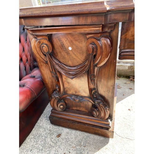 3078 - A VICTORIAN MAHOGANY PEDESTAL SIDEBOARD WITH BOW FRONT, SINGLE DRAWER AND SIDE CUPBOARD WITH CARVED ... 