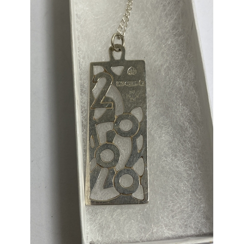 653 - A MARKED SILVER NECKLACE WITH A LARGE MILLENIUM PENDANT