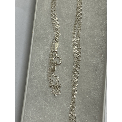 653 - A MARKED SILVER NECKLACE WITH A LARGE MILLENIUM PENDANT