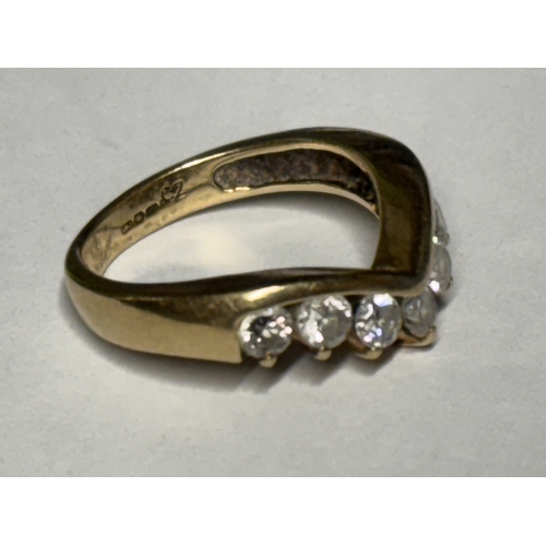 519 - A MARKED 9 CARAT GOLD WISHBONE RING WITH SEVEN STONES SIZE K