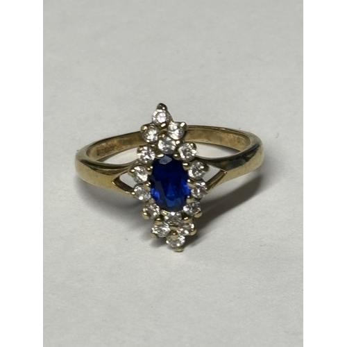 521 - A MARKED 9 CARAT GOLD RING WITH A CENTRE SAPPHIRE SURROUNDED BY DIAMONDS SIZE N