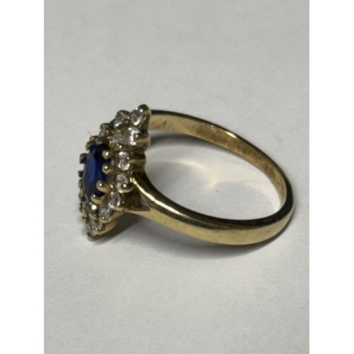 521 - A MARKED 9 CARAT GOLD RING WITH A CENTRE SAPPHIRE SURROUNDED BY DIAMONDS SIZE N