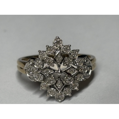 527 - A MARKED 9 CARAT GOLD RING WITH DIAMONDS IN A DECORATIVE CLUSTER DESIGN