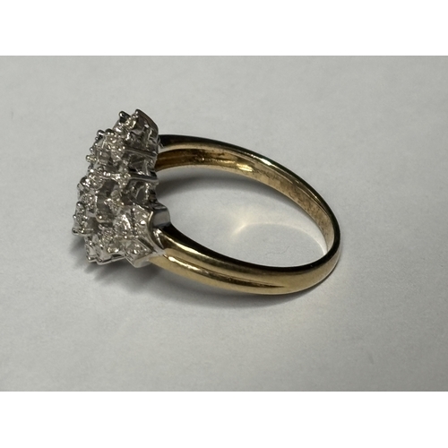 527 - A MARKED 9 CARAT GOLD RING WITH DIAMONDS IN A DECORATIVE CLUSTER DESIGN