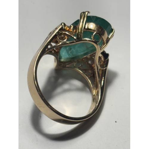 528 - A MARKED 14 CARAT GOLD RING WITH LARGE TEARDROP SHAPED EMERALD WITH DIAMONDS TO EACH SIDE SIZE N/O I... 