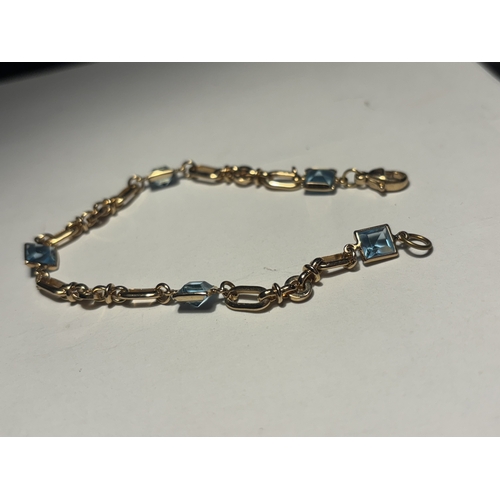 542 - A TESTED TO 9 CARAT GOLD AND POSSIBLY AQUAMARINE BRACELET IN A PRESENTATION BOX