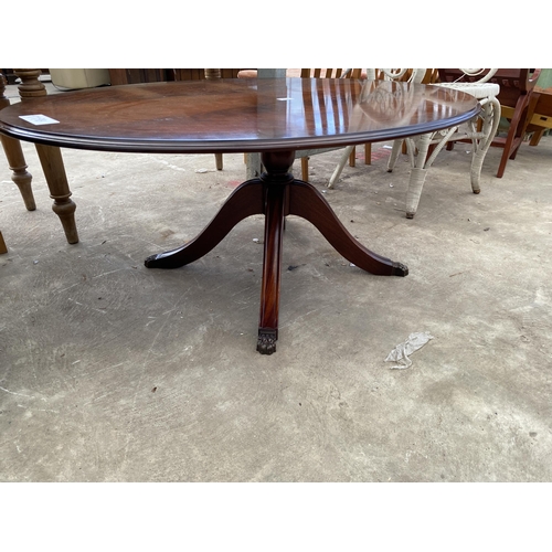 2721 - AN OVAL MAHOGANY AND CROSSBANDED COFFEE TABLE ON PEDESTAL BASE, 48