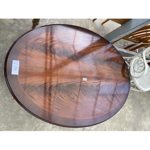 2721 - AN OVAL MAHOGANY AND CROSSBANDED COFFEE TABLE ON PEDESTAL BASE, 48