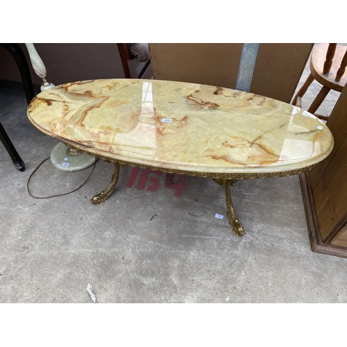 2724 - AN OVAL ONYX COFFEE TABLE ON GILT METAL BASE, 48