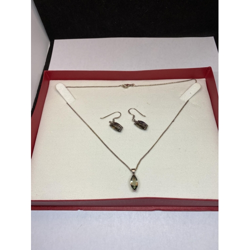 548 - A MARKED SILVER EARRING AND NECKLACE SET WITH SMOKEY STONES IN A PRESENTATION BOX