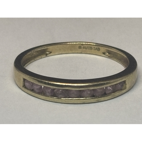 507 - A MARKED 9 CARAT GOLD RING WITH NINE IN LINE AMETHYSTS SIZE Q GROSS WEIGHT 2.03 GRAMS