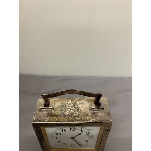 5 - A HALLMARKED BIRMINGHAM SILVER MANTLE CLOCK WITH A HANDLE AND BUN FEET, HEIGHT 8.5CM