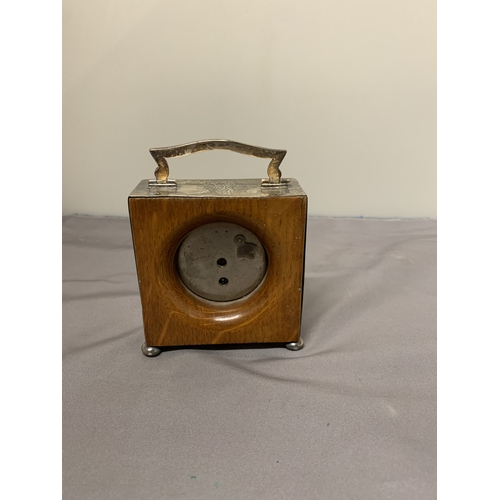 5 - A HALLMARKED BIRMINGHAM SILVER MANTLE CLOCK WITH A HANDLE AND BUN FEET, HEIGHT 8.5CM