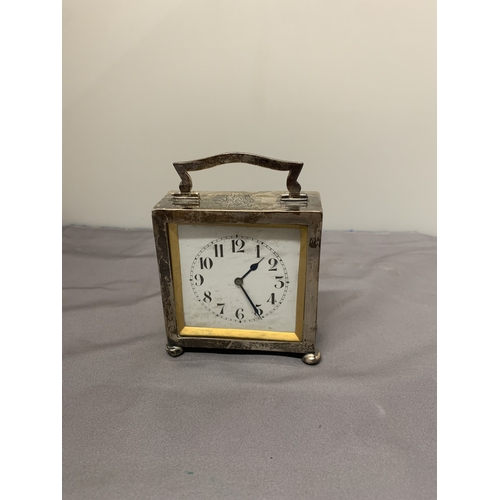 5 - A HALLMARKED BIRMINGHAM SILVER MANTLE CLOCK WITH A HANDLE AND BUN FEET, HEIGHT 8.5CM