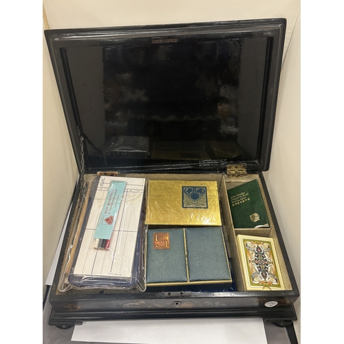 18 - A VICTORIAN EBONY GAMES BOX WITH AN INLAID MOTHER OF PEARL CHESS BOARD TO THE TOP AND BRIDGE PLAYING... 