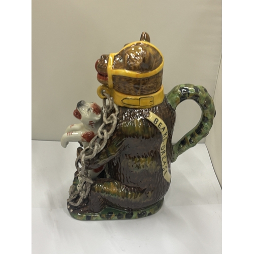 24 - A MAJOLICA STYLE BEAR JUG DEPICTING A CHAINED BEAR HOLDING A DOG, HEIGHT 29CM