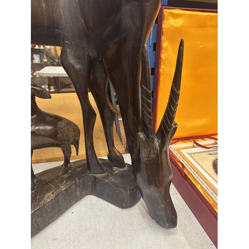 39 - A LARGE HARDWOOD CARVING OF A GAZELLE AND FAWN, HEIGHT 59CM, WIDTH 43CM