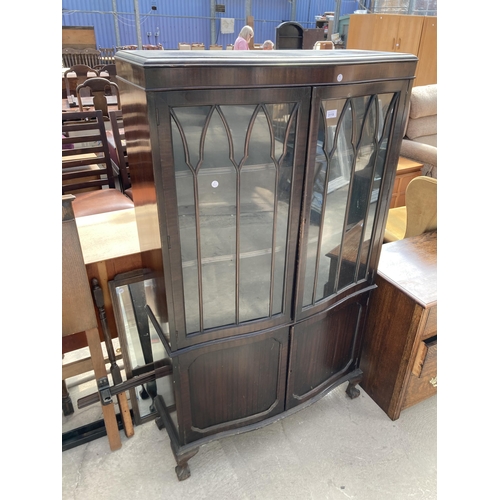 3119 - A MAHOGANY TWO DOOR DISPLAY CABINET WITH SERPENTINE FRONT, CUPBOARDS TO BASE ON BALL AND CLAW FEET, ... 