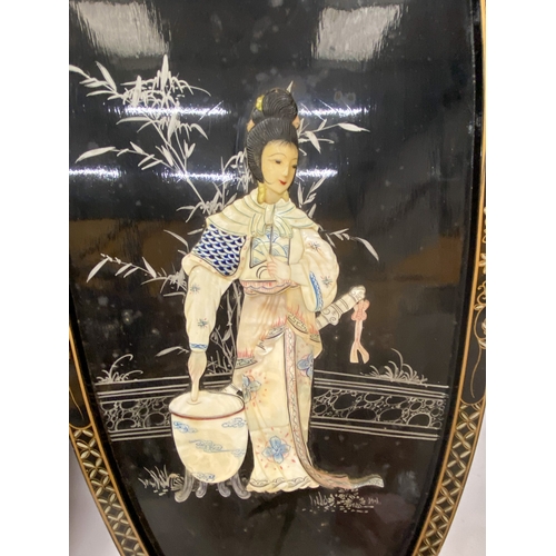 15 - A PAIR OF CHINOISERIE  BLACK LACQUER DECORATED WALL PANELS DEPICTING LADY WARRIORS WITH OVERLAID MOT... 