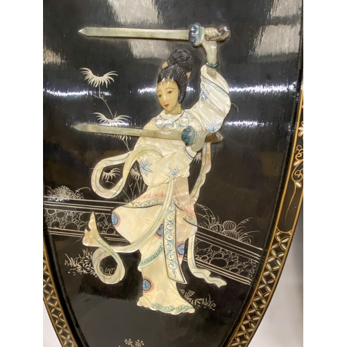 15 - A PAIR OF CHINOISERIE  BLACK LACQUER DECORATED WALL PANELS DEPICTING LADY WARRIORS WITH OVERLAID MOT... 