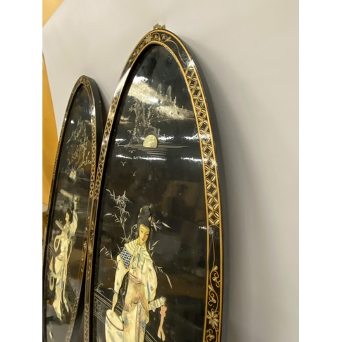 15 - A PAIR OF CHINOISERIE  BLACK LACQUER DECORATED WALL PANELS DEPICTING LADY WARRIORS WITH OVERLAID MOT... 