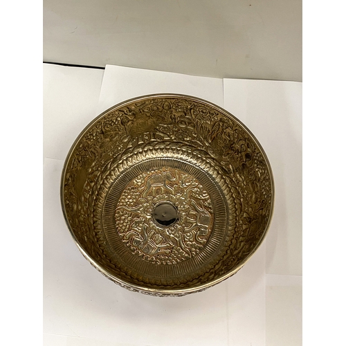 25 - A CAMBODIAN WHITE METAL BOWL WITH REPOUSSE DECORATION FIGURAL WITH ELEPHANTS AND FOLIATE SCROLLWORK ... 