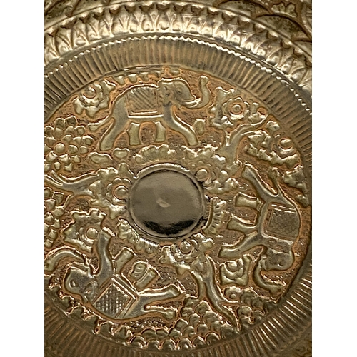 25 - A CAMBODIAN WHITE METAL BOWL WITH REPOUSSE DECORATION FIGURAL WITH ELEPHANTS AND FOLIATE SCROLLWORK ... 