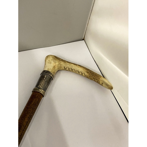 5 - A VINTAGE ENGLISH RIDING CROP WITH AN ANTLER HANDLE AND HALLMARKED SILVER COLLAR
