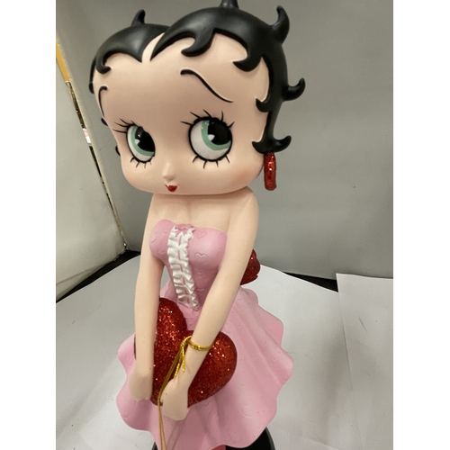 A BETTY BOOP FIGURE IN A PINK DRESS