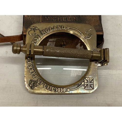 39 - A BRASS MICHELIN MAGNIFYING GLASS IN A LEATHER CASE
