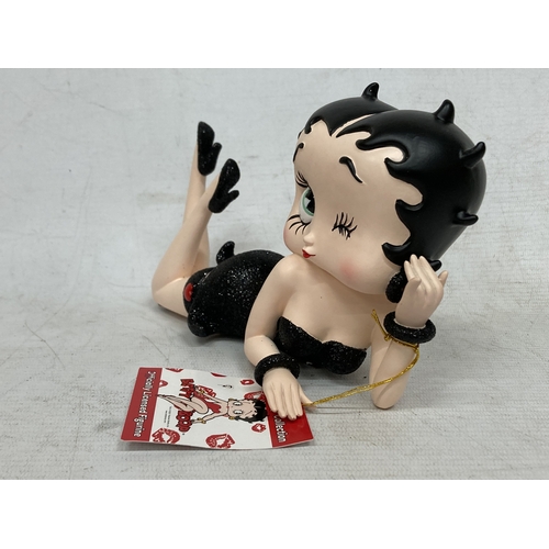 57 - A BETTY BOOP LYING DOWN FIGURE IN A BLACK DRESS