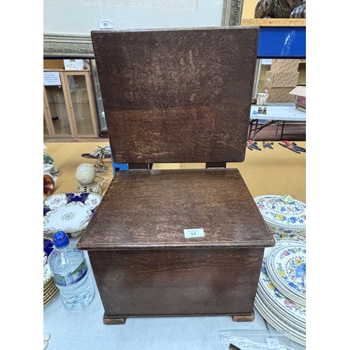 34 - A VINTAGE OAK SEWING TABLE WITH CONTENTS