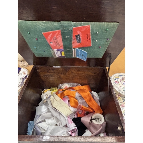 34 - A VINTAGE OAK SEWING TABLE WITH CONTENTS