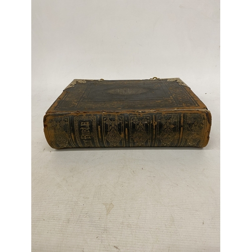 14 - A LEATHER BOUND HOLY BIBLE WITH BRASS DETAIL