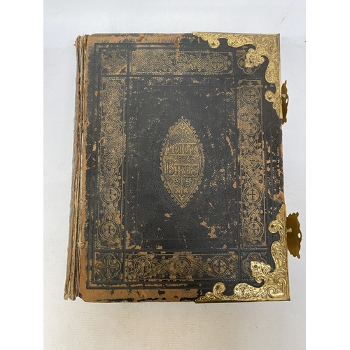 14 - A LEATHER BOUND HOLY BIBLE WITH BRASS DETAIL