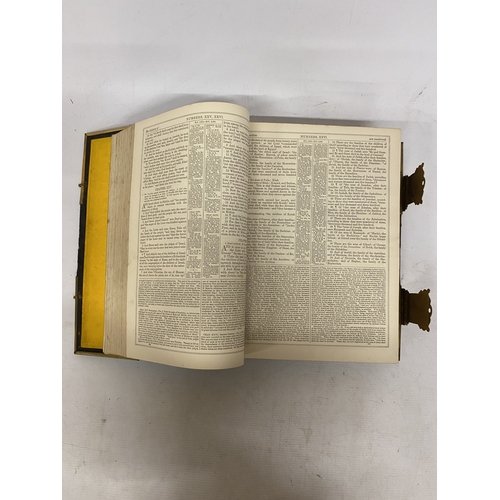 14 - A LEATHER BOUND HOLY BIBLE WITH BRASS DETAIL