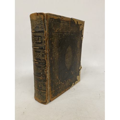 14 - A LEATHER BOUND HOLY BIBLE WITH BRASS DETAIL