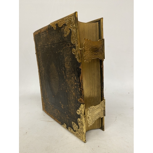 14 - A LEATHER BOUND HOLY BIBLE WITH BRASS DETAIL