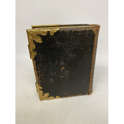 14 - A LEATHER BOUND HOLY BIBLE WITH BRASS DETAIL