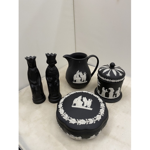 20 - A WEDGWOOD BLACK BASALT JASPERWARE CREAMER/MILK JUG TOGETHER WITH A BLACK BASALT KING AND QUEEN CHES... 