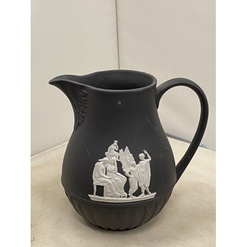 20 - A WEDGWOOD BLACK BASALT JASPERWARE CREAMER/MILK JUG TOGETHER WITH A BLACK BASALT KING AND QUEEN CHES... 