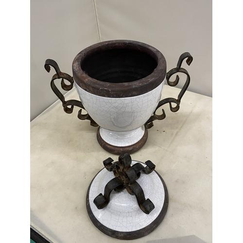 300 - TWO VINTAGE WHITE CERAMIC AND CAST IRON URNS