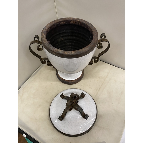 300 - TWO VINTAGE WHITE CERAMIC AND CAST IRON URNS