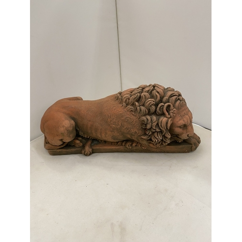 6 - A PAIR OF TERRACOTTA SCULPTURES OF RECUMBENT LIONS