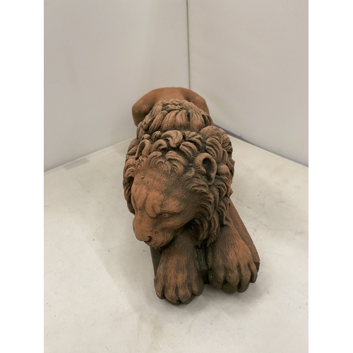 6 - A PAIR OF TERRACOTTA SCULPTURES OF RECUMBENT LIONS