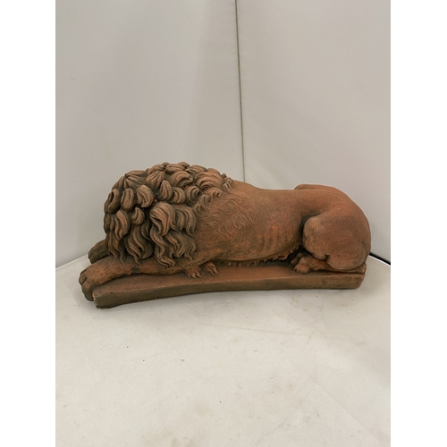 6 - A PAIR OF TERRACOTTA SCULPTURES OF RECUMBENT LIONS