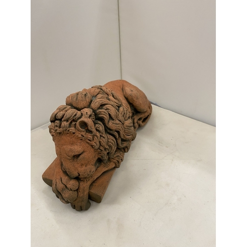 6 - A PAIR OF TERRACOTTA SCULPTURES OF RECUMBENT LIONS