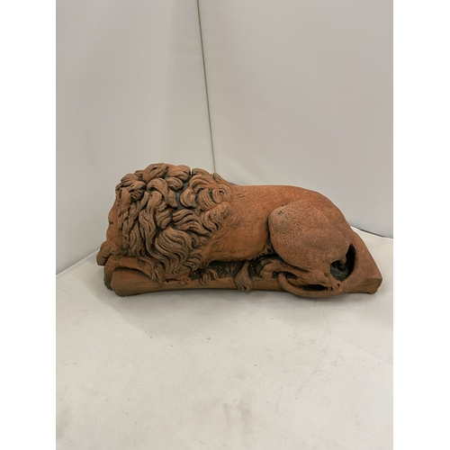 6 - A PAIR OF TERRACOTTA SCULPTURES OF RECUMBENT LIONS