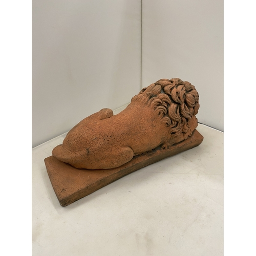 6 - A PAIR OF TERRACOTTA SCULPTURES OF RECUMBENT LIONS